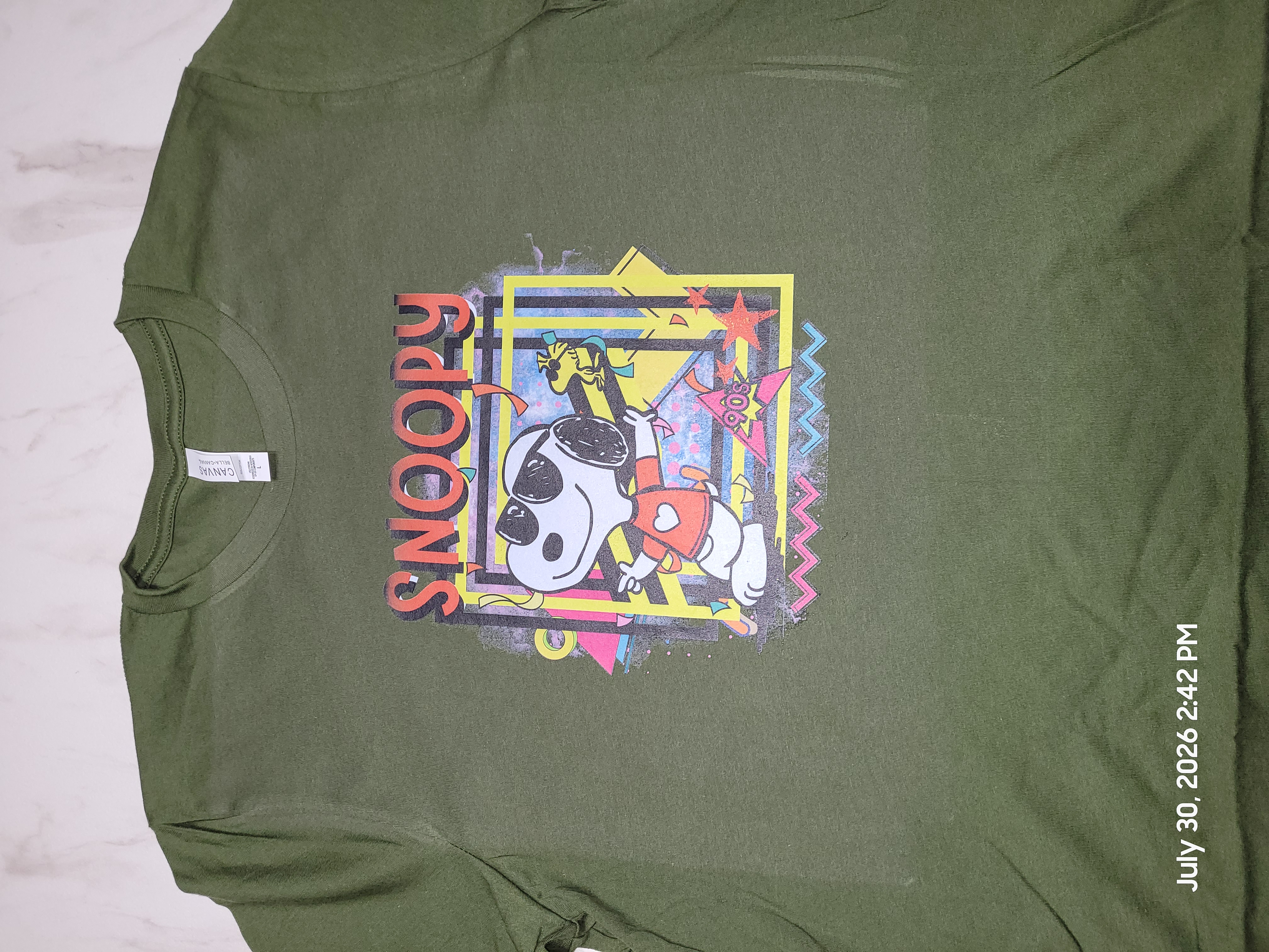 Green adult T-shirt with a colorful Snoopy design