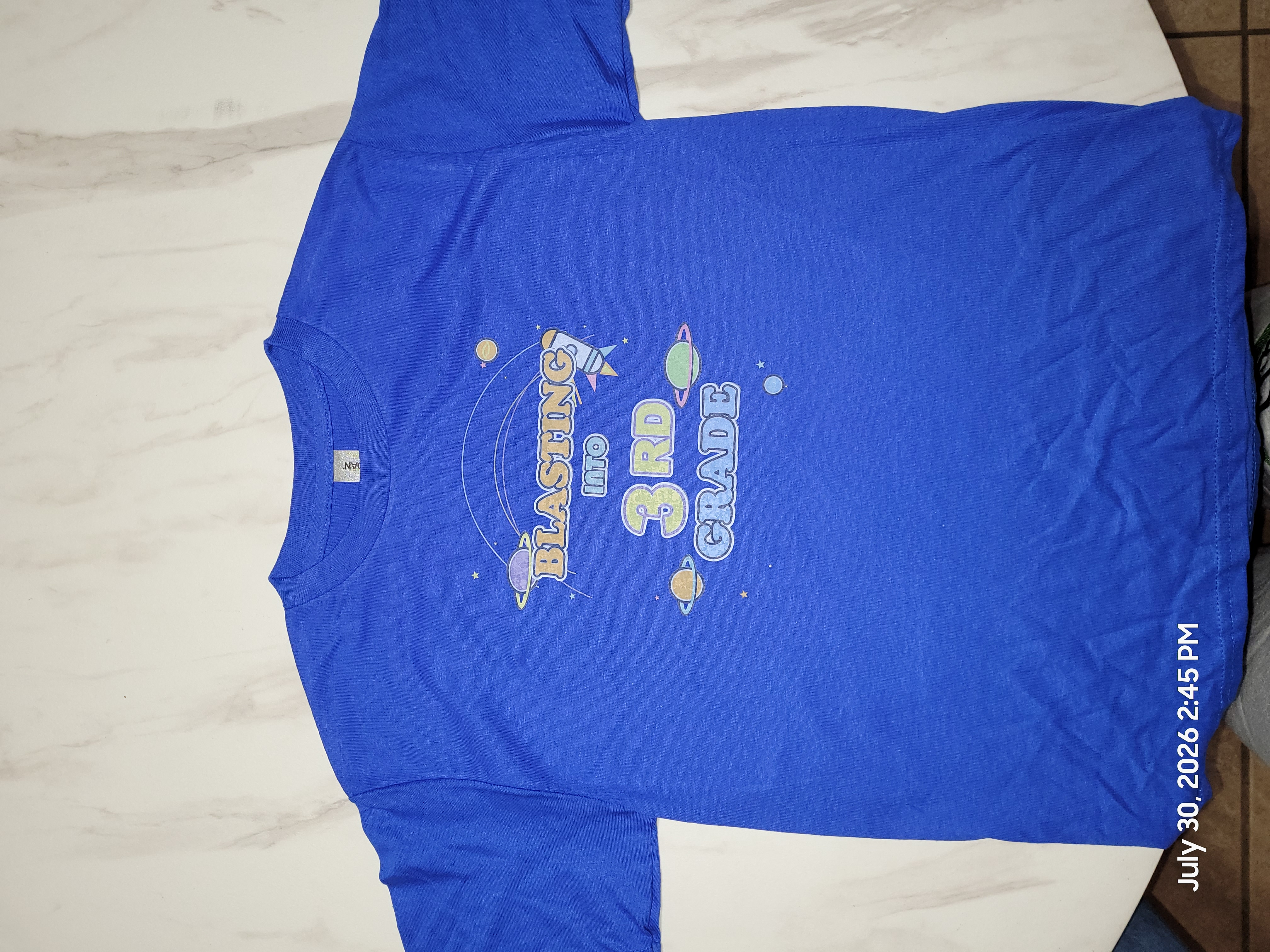 Blue children's T-shirt with a Blasting Into Third Grade design